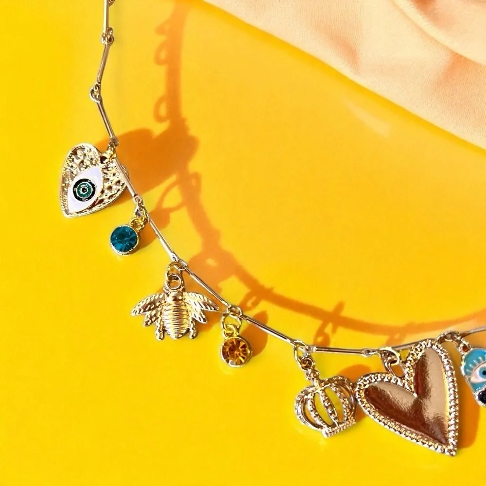 Unique and Gorgeous Gold toned Necklace with Varying Blue and Yellow Charms